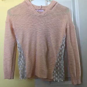 pink sweater with lace at the sides